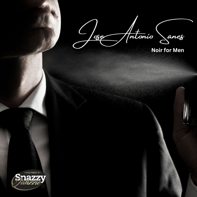 A man in a suit sprays the fragrance near his neck. The elegant text reads "Jose Antonio Sanes Noir for Men By Snazzy Jahzzie," set against a dark background. A small logo in the bottom left corner reads "Hand Made by Snazzy Jahzzie LLC," hinting at its luxurious essential oils blend.