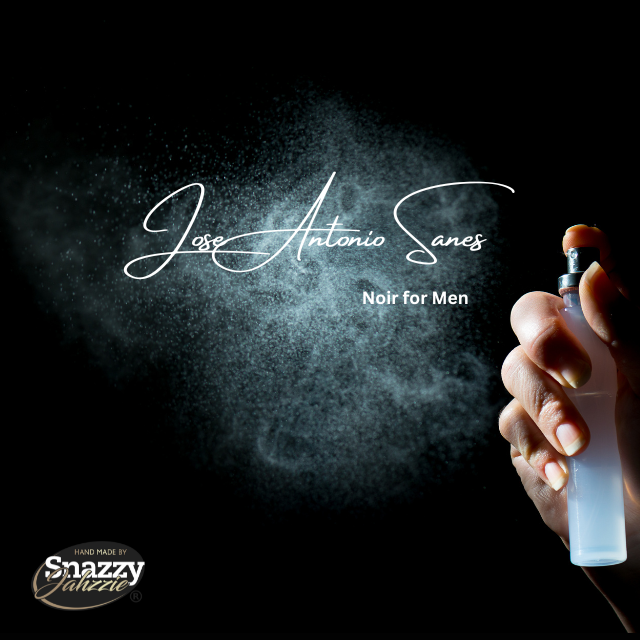 A hand is holding a cologne bottle, spraying a mist of fragrance against a dark background. The text reads, "Jose Antonio Sanes Noir for Men By Snazzy Jahzzie." In the bottom left corner, there's a logo saying, "Hand Made by Snazzy Jahzzie LLC," highlighting the essential oils in every bottle.